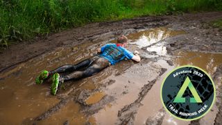 Trail runner sprawled in muddy puddle