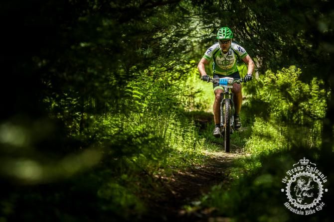 Tracy Michuad racing the Time Trial through a tunnel of green