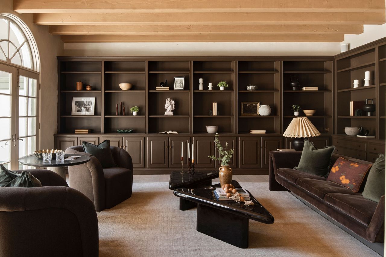 A living room with brown painted open shelves