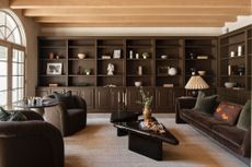 A living room with brown painted open shelves