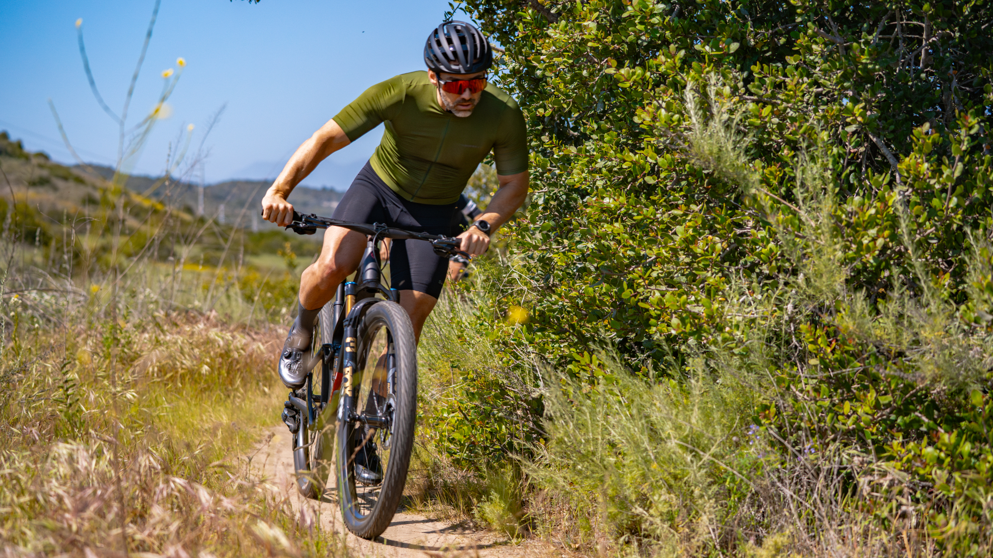 Shimano's new groupset being ridden on a dry singletrack trail
