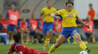 PHILADELPHIA, PA - SEPTEMBER 25: Forward Hanna Ljungberg #10 of Sweden dribbles around Hye Yong Jon #17 of Korea DPR during their FIFA Women's World Cup match at Lincoln Financial Field on September 25, 2003 in Philadelphia, Pennsylvania. (Photo by Ezra Shaw/Getty Images)