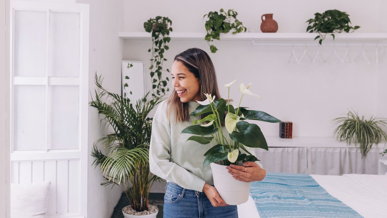 Smiling woman among her houseplants in calming room