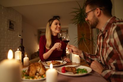 image showing a couple having a romantic dinner at home