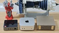 Sipeed MaixStation mini PC beside an Apple Mac mini and an Nvidia DGX Spark on a desk