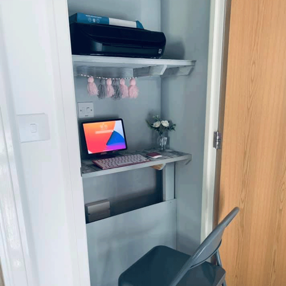 cupboard with wooden door laptop and folding chair