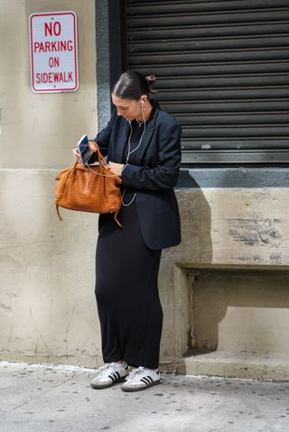 woman wearing blazer, trousers, and adidas sambas