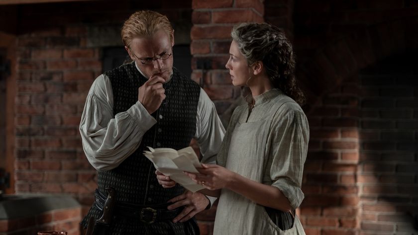 Claire showing Jamie a piece of paper in Outlander Season 8