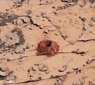A close-up image of the 2-inch-deep (5 centimeters) hole Curiosity produced using a new drilling technique on May 20, 2018. The hole is about 0.6 inches (1.6 cm) wide. This image, taken by Curiosity's Mast Camera, has been white-balanced and contrast-enhanced.