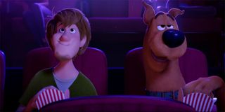 Shaggy and Scooby Doo eating popcorn in a movie theater in SCOOB!