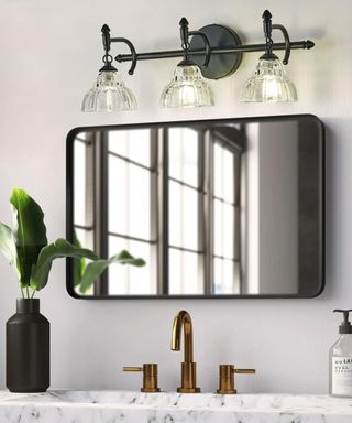 A bathroom with vanity lighting