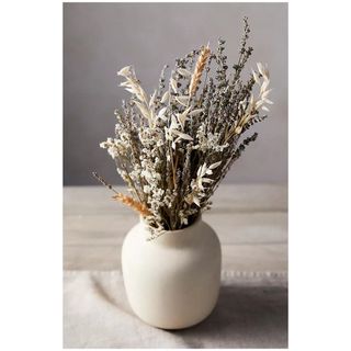 A bunch of dried lavender in a stoneware pot