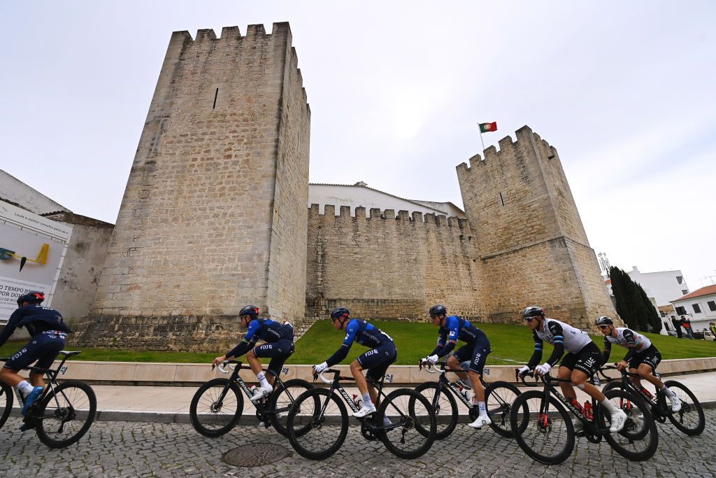 LAGOS PORTUGAL FEBRUARY 15 Miles Scotson of Australia Jake Stewart of United Kingdom Stefan Kung of Switzerland and Team Groupama FDJ and a general view of the peloton passing through Loul city walls during the 49th Volta ao Algarve em Bicicleta 2023 Stage 1 a 2002km stage from Portimo to Lagos VAlgarve2023 on February 15 2023 in Lagos Portugal Photo by Tim de WaeleGetty Images