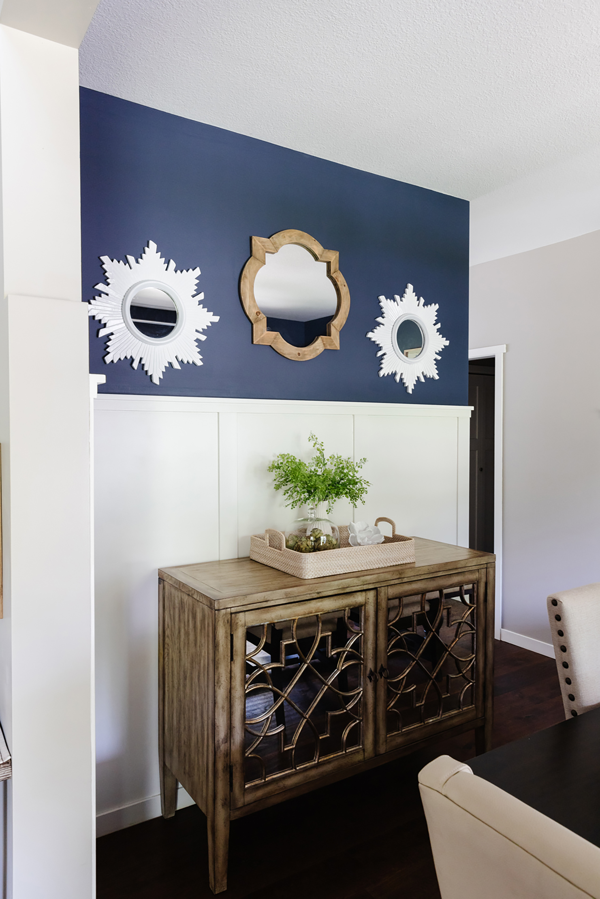 three decorative mirrors on hallway wall