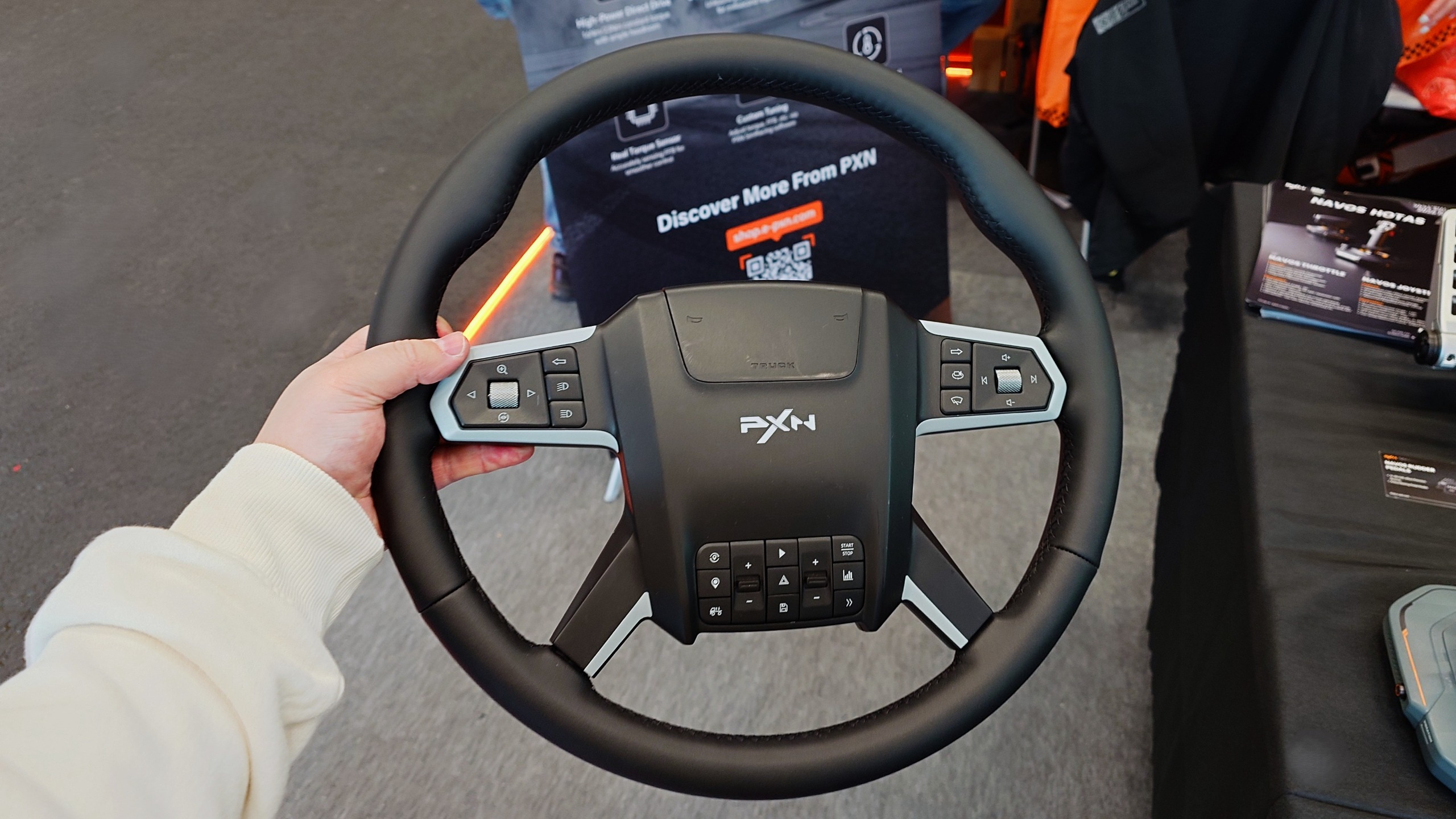 Close up photos of the new and unreleased PXN truck simulator wheel showing the design and controls.