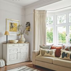 Living room with uPVC bay window located behind the sofa