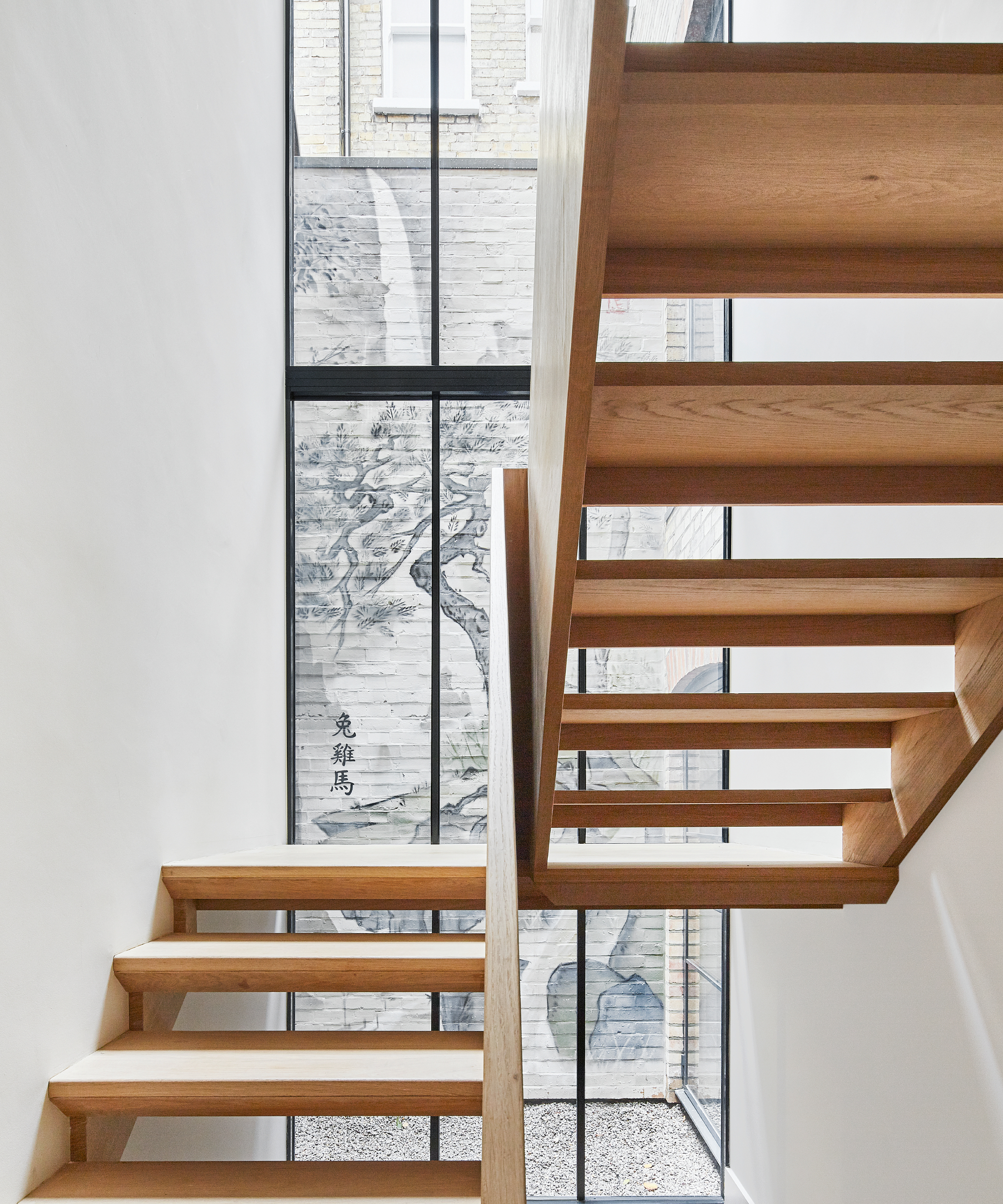 wooden open tread staircase with large stair lightwell