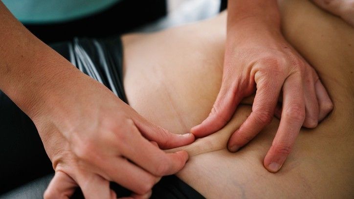 A midwife massaging a patients abdomen