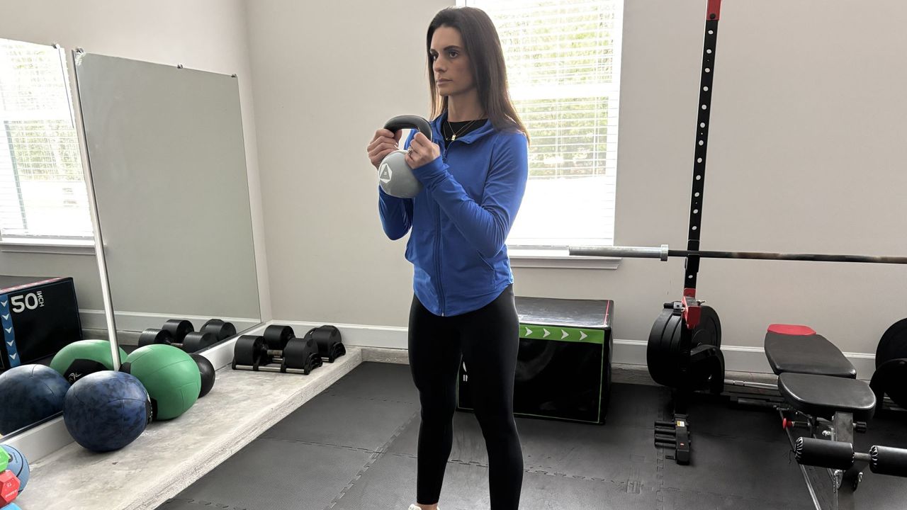 Tami Smith performs a kettlebell squat
