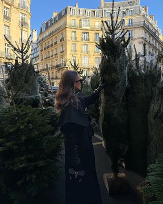 Content creator Emma Leger poses near Christmas tree while visiting Paris, France