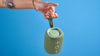 A green Tribit StormBox Mini+ speaker