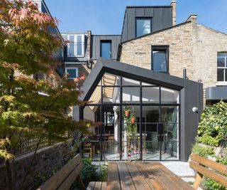 A contemporary pitched roof extension with aluminium frame and glass frontage