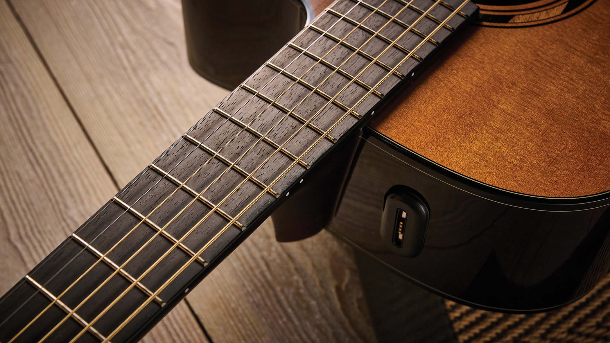 The Yamaha TransAcoustic TAG3 C is a cutaway acoustic guitar with a sandburst finished, photographed in closeup