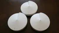 The TP-Link Deco M5 on a dark table