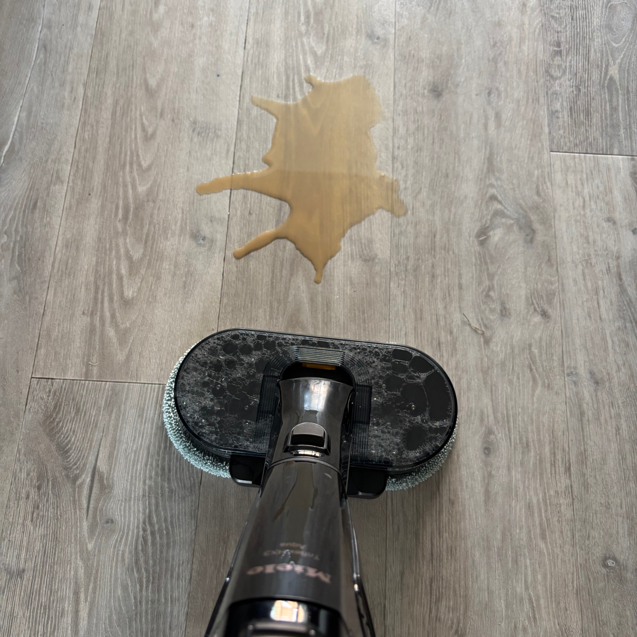 Miele Triflex HX3 Aqua mop cleaning up coffee spill