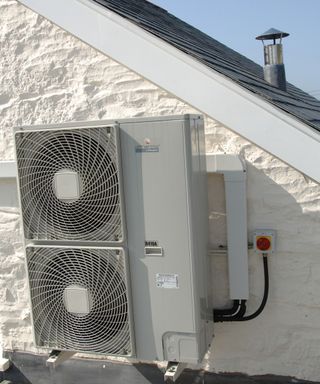 A small air sourced heat pump on the side of a building in Combe Martin North Devon England