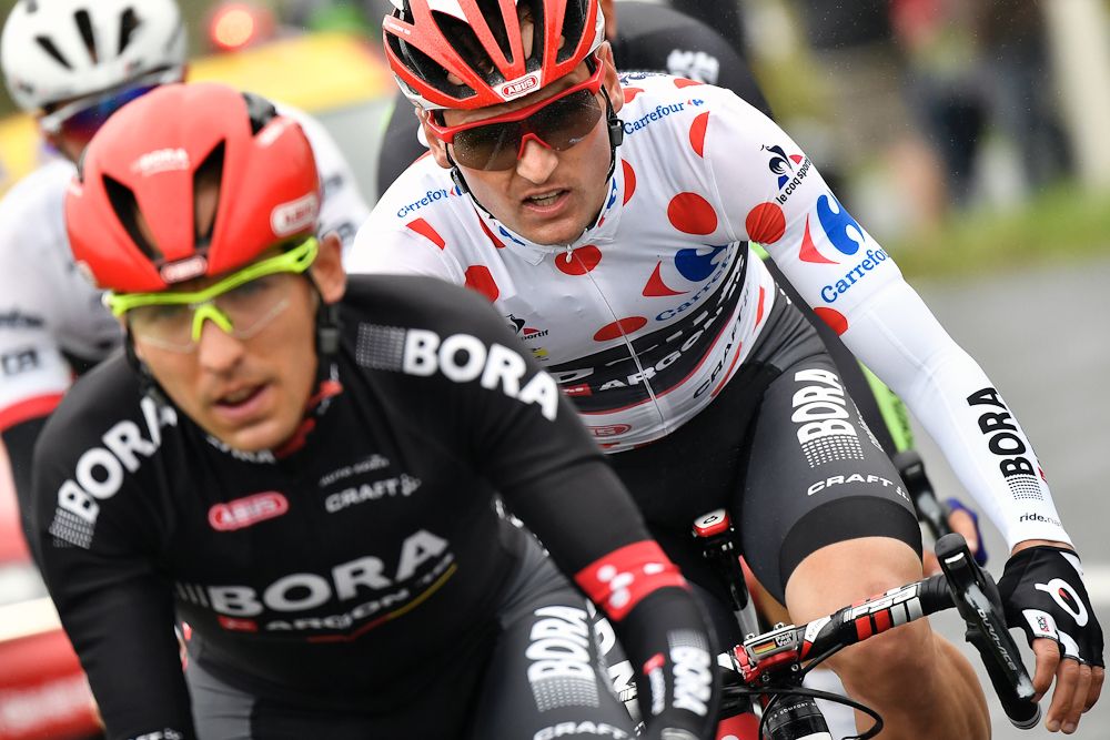 Cesare Benedetti (L) and Germany's Paul Voss (R), wearing the best climber's polka dot jersey, ride in a breakaway during the 183 km second stage of the 103rd edition of the Tour de France