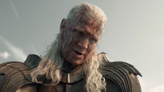 Daemon Targaryen looking down with blood splashed onto his face in House of the Dragon Season 3