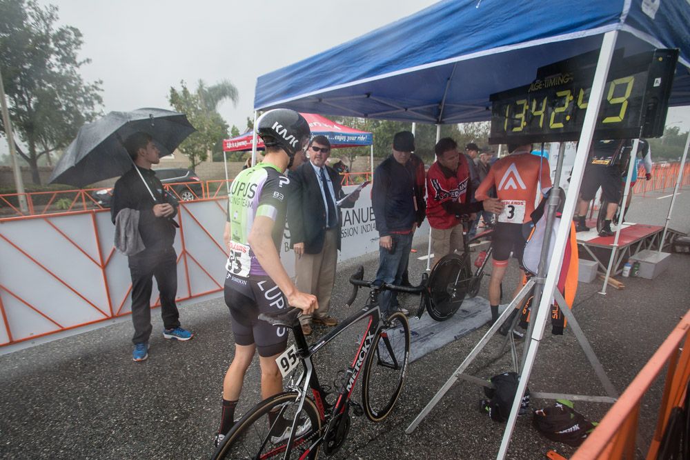 Riders make their way to the start as the rain moves in