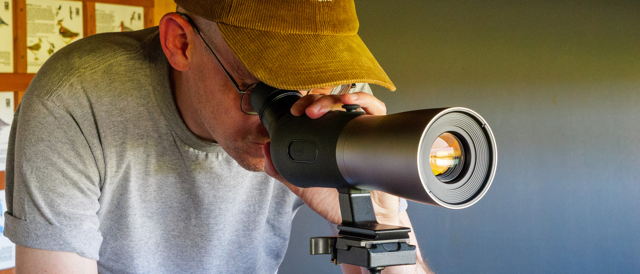 Bird spotting scope on tripod in bird watching hide