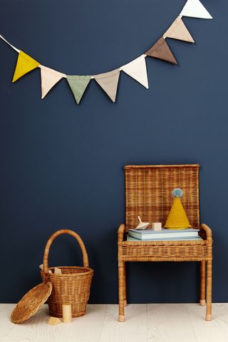 Storie stool in front of a dark blue wall from Olli Ella