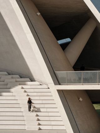 sun tower by open architecture, a curved, sloping, concrete tower, half open to the elements and looking out towards the sea