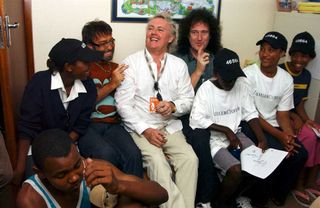 Paul Rodgers, Roger Taylor and Brian May of the band Queen visit the George Child and Family Welfare Society Hostel, a hostel for HIV/AIDS suffers, ahead of tomorrow's charity concert "46664 South Africa", on March 18, 2005 in George, South Africa