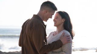 Tim and Lucy smiling at each other on the beach in The Rookie Season 8 finale.