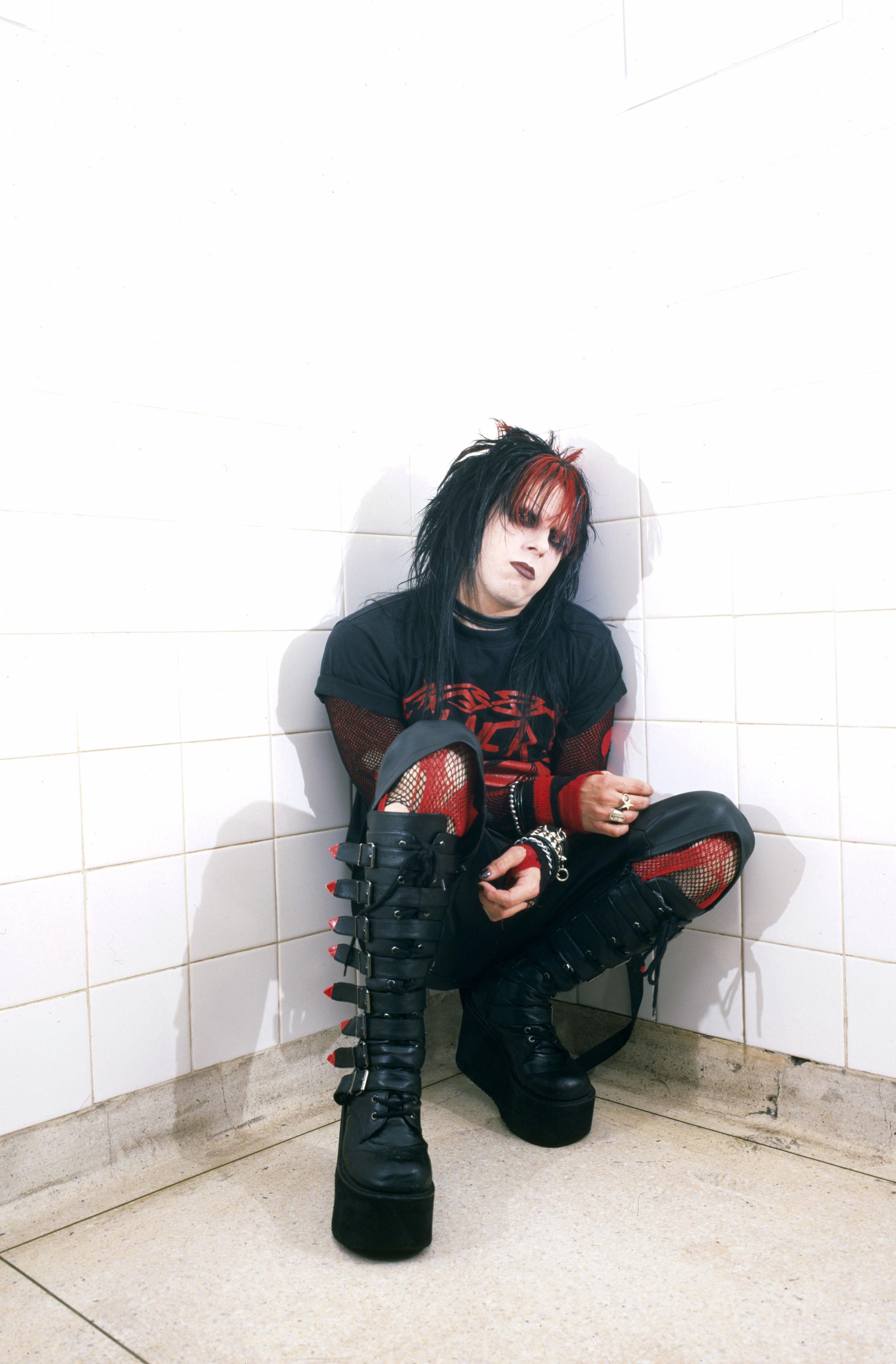 Murderdolls members posing in a public bathroom