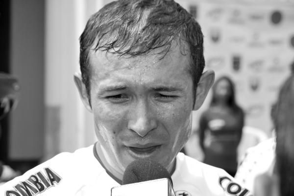 A Colombian rider speaks to the media after the team's win