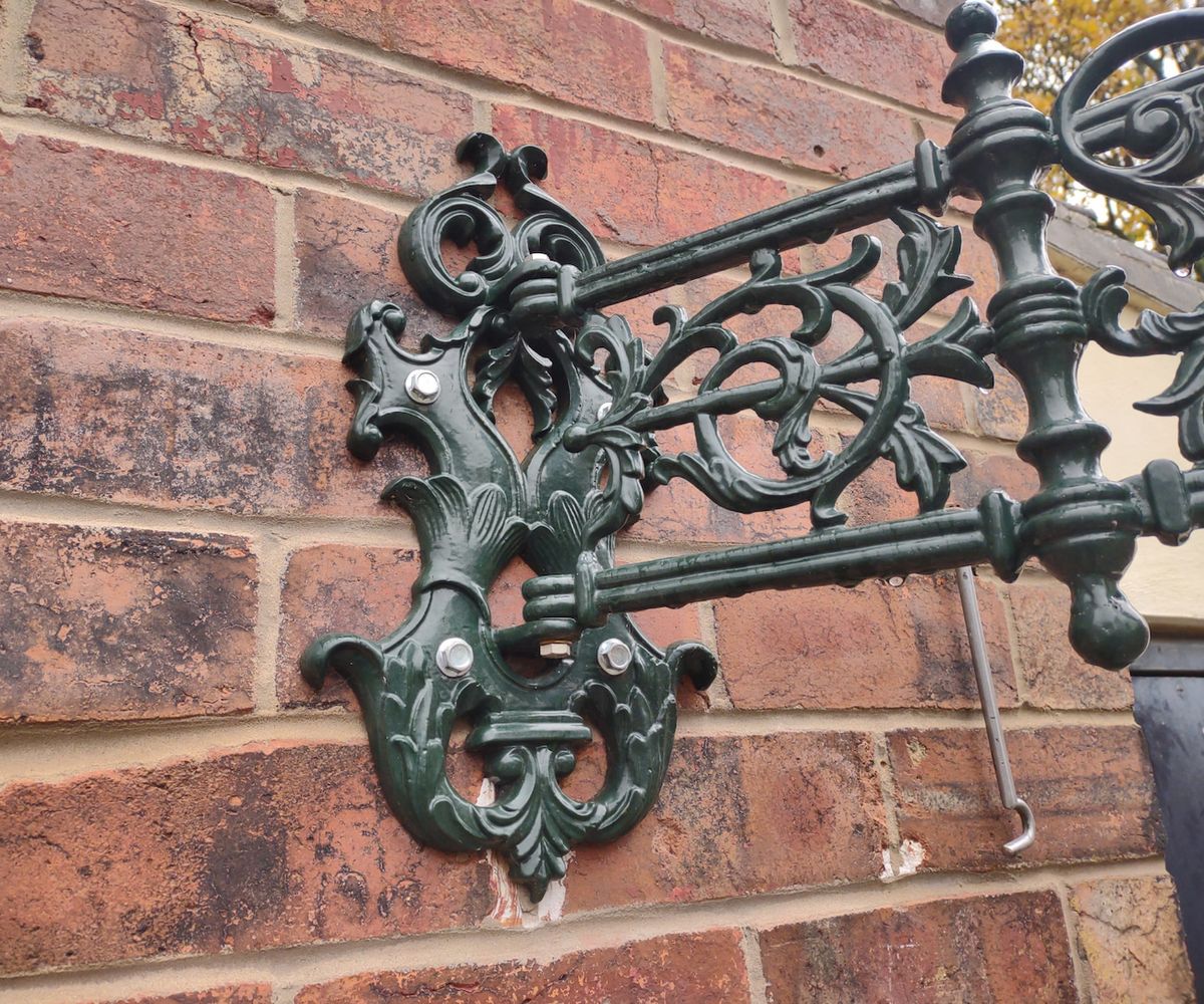 An iron bracket that has been fixed to a brick wall