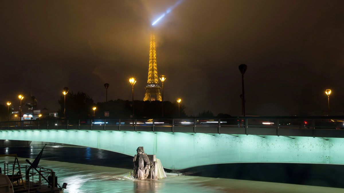 Water laps at the waist of a statue at the Alma bridge in Paris after the Seine reaches its highest level in three decades