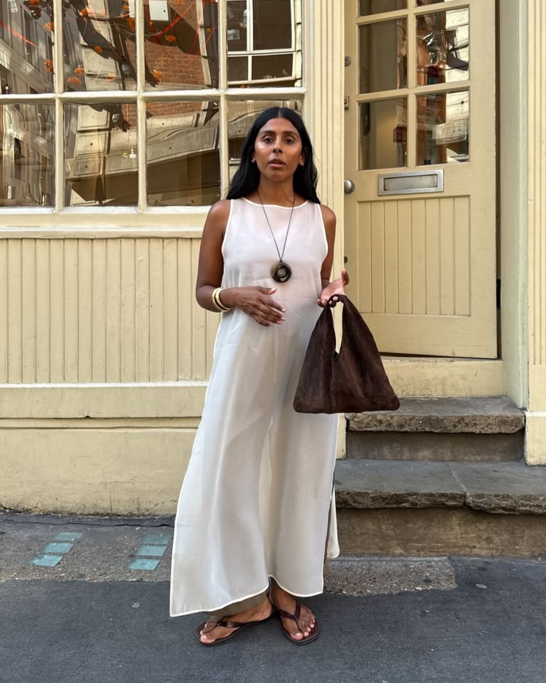 Best thong sandals @monikh wearing a cream maxi dress and brown thong sandals