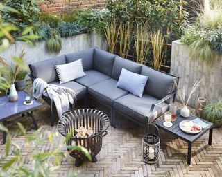 Maizy sofa from Dobbies on patio with ornamental grasses