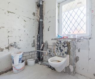 bathroom renovation with stripped walls