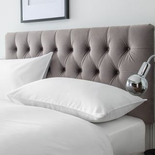 grey velvet headboard and pillows