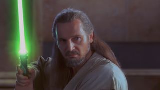 Qui Gon Jinn holding lightsaber in The Phantom Menace