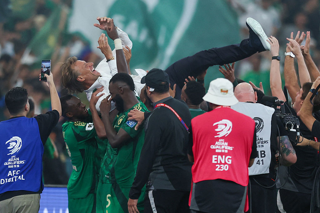 Saudi Arabia players celebrate with French coach Herve Renard during the FIFA World Cup 2026 Asian qualifier football match between Saudi Arabia and Iraq at King Abdullah Sports City&amp;nbsp;in Jeddah on October 14, 2025. (Photo by Abdel Ghani BASHIR / AFP)