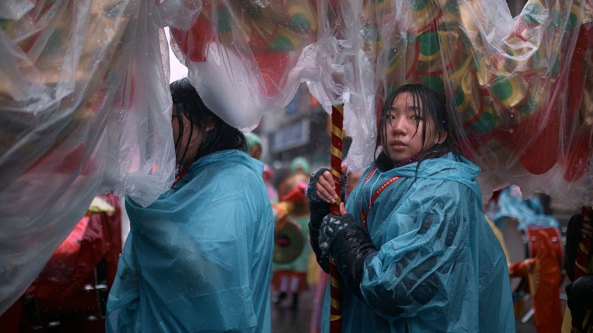 
                                People carry a dragon through the rain during the Chinese Lunar New Year parade in Chinatown, New York 
                            