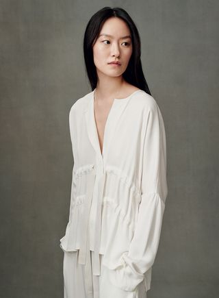 Model wearing white shirt and pant
